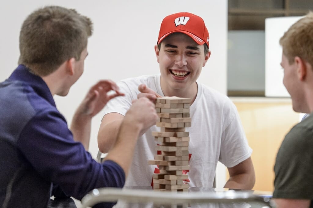 Student Keegan Gruss plays a game of Jenga with his friends.