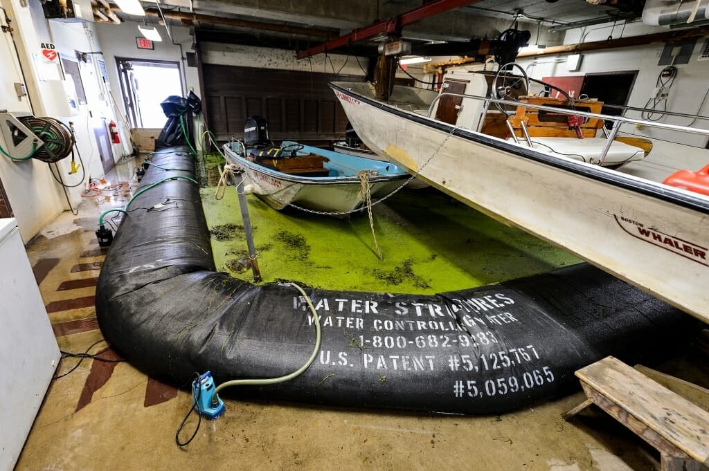 An inflatable dike holds back floodwaters in a building's basement.