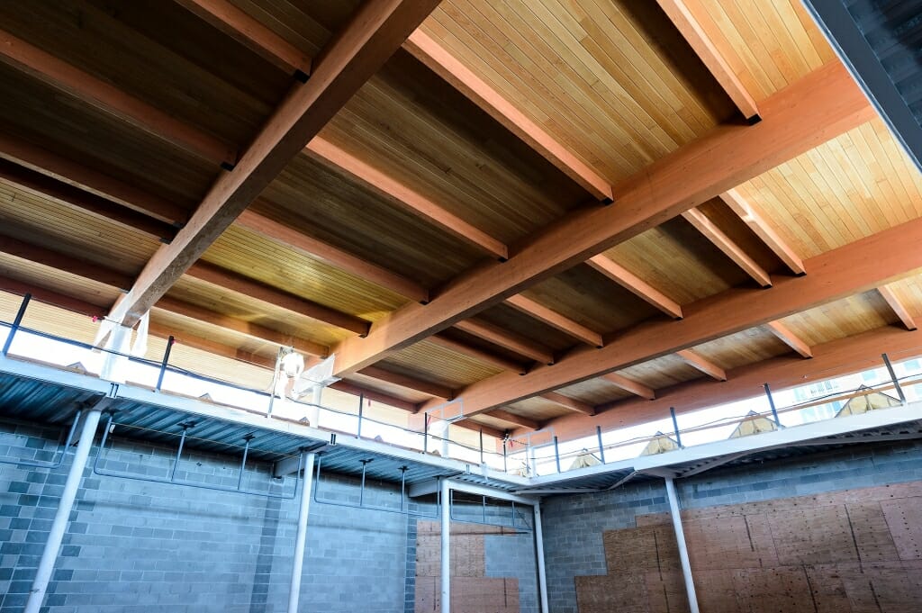 A ceiling of wooden beams and planks is shown in the Collins Recital Hall.