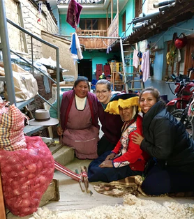 Lorenz poses with some of the women in Peru she employs to make CAMPO's clothes.