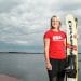 Gabbie Taschwer stands on a dock, holding her water skis, with Lake Mendota in the background.