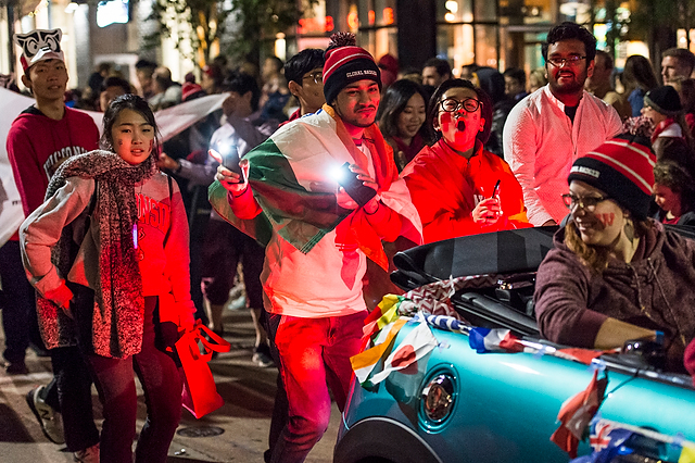 Thousands of spectators cheer as spirited students dance and parade floats -- including this one hosted by International Student Services (ISS) -- travel down State Street as part of the Homecoming Parade.