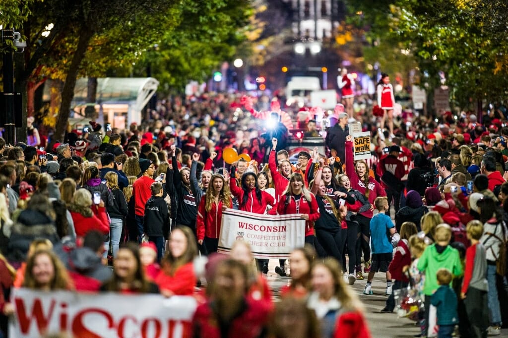 Thousands of spectators cheer as spirited students dance and parade floats travel down State Street during the University of Wisconsin-Madison's Homecoming Parade.