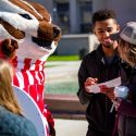 Bucky Badger discusses voting plans with several students during one of last week's get out the vote events.
