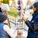 Courtney Henson-Brienen, left, Kase Wheatly, right, and Bernie Isaac, back left, work to install yarn bombs on light poles on Bascom Hill.