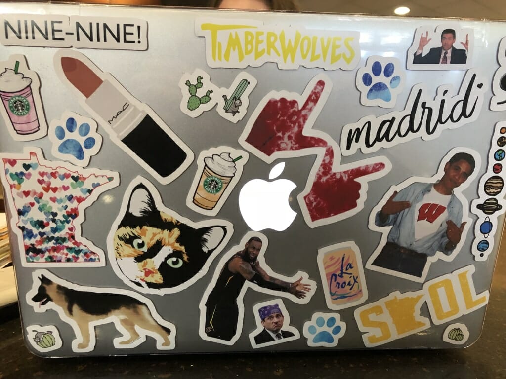 Freshman Claire McQuiston's laptop which is covered with more than a dozen stickers. Some reference Minnesota, some reference madison and the UW, one is a photo of Lebron James, and a few are of Starbucks coffee