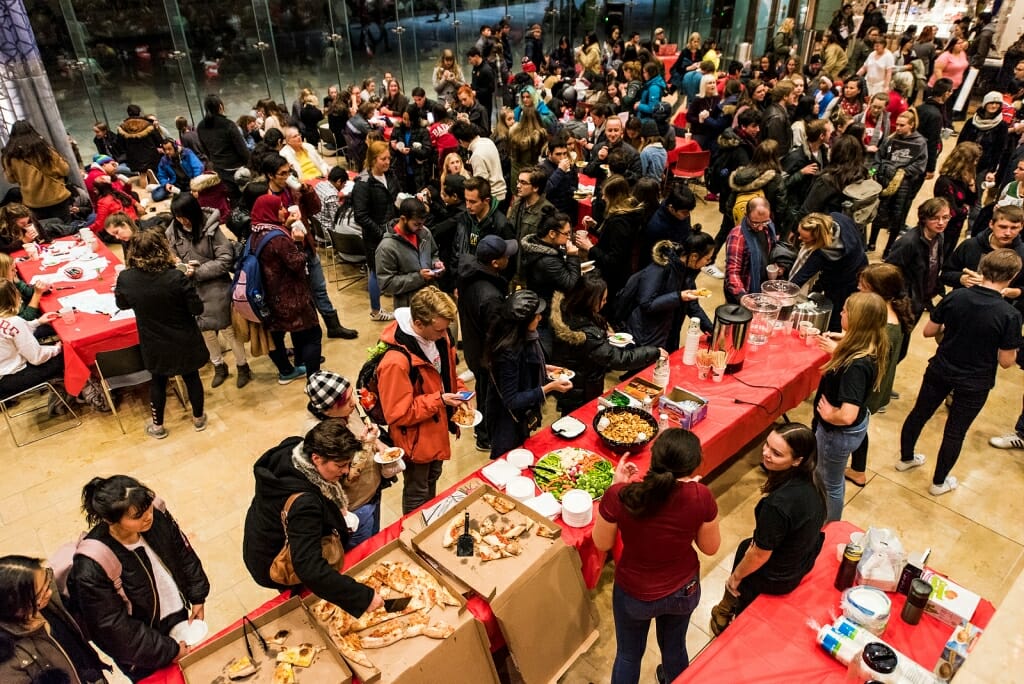 Students and members of the public socialize and enjoy food and drink during the event.