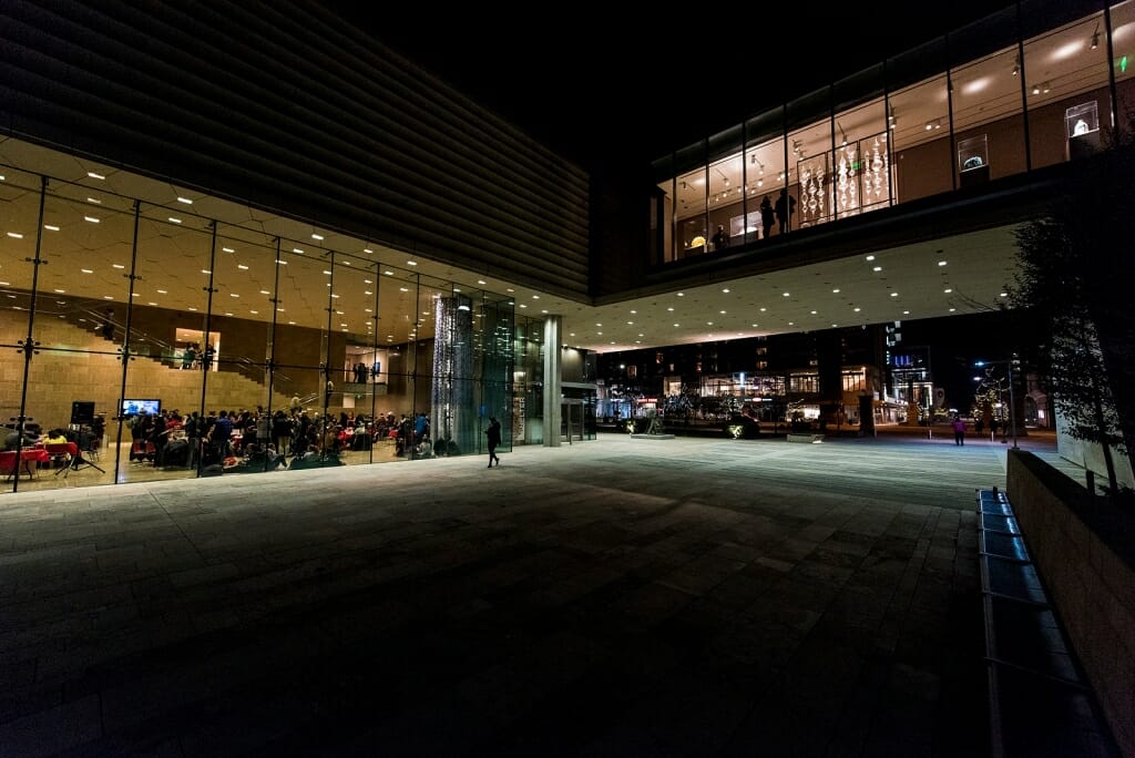 Guests wait at the entrance of the Chazen and peek through windows on the second floor during Night at the Museum.