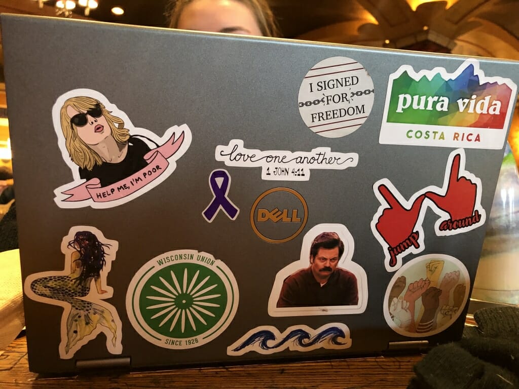 Junior Serena Haley's laptop which features a Costa Rica sticker, one form the Wisconsin Union, another of a mermaid, and one "Love one another" bible quotes, among others