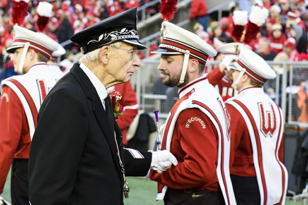 Leckrone shakes hands and shares a moment with a band member.