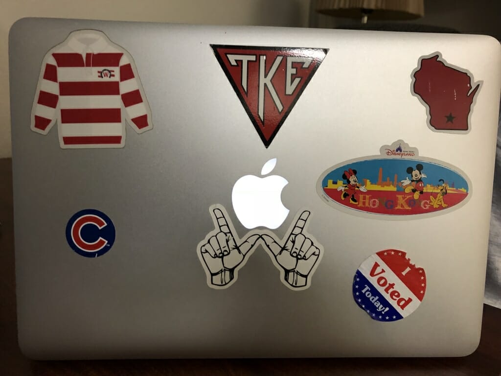 Senior Kyle Casey's laptop which features a Chicago Cubs sticker, three referencing the UW and Madison, and an "I Voted" sticker, among others. 