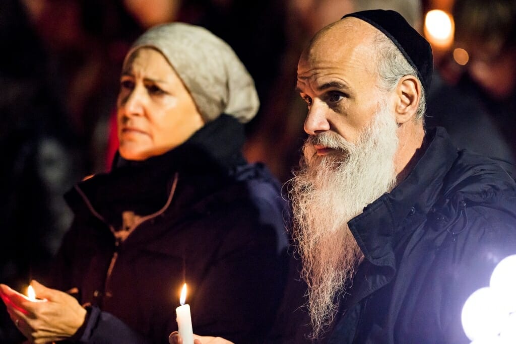 Photo: Rabbi holding lighted candle