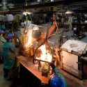 Photo: Workers pouring molten metal in foundry