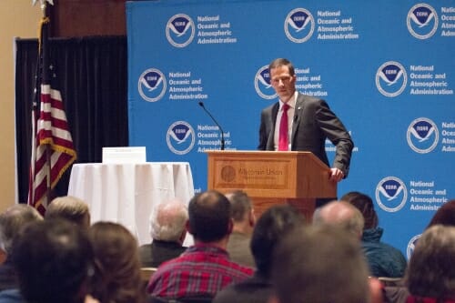 Photo: Neil Jacobs speaking at podium
