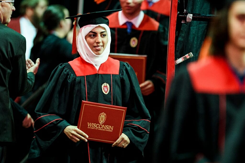 Photo of a graduate holding her diploma cover.