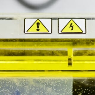 Photo: Yellow tube with warning labels on it