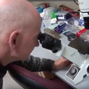 Photo from video: James Thomson looking into a microscope
