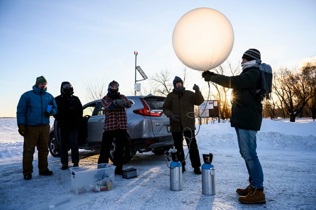 On the second of two unusually cold days in Madison, Petty gathered with a group of students and colleague Ankur Desai at sunrise on University Bay. Temperatures hovered around minus 24-degrees Fahrenheit. They filled a weather balloon with helium in preparation to gather measurements of temperature and humidity for several miles above Earth’s surface.