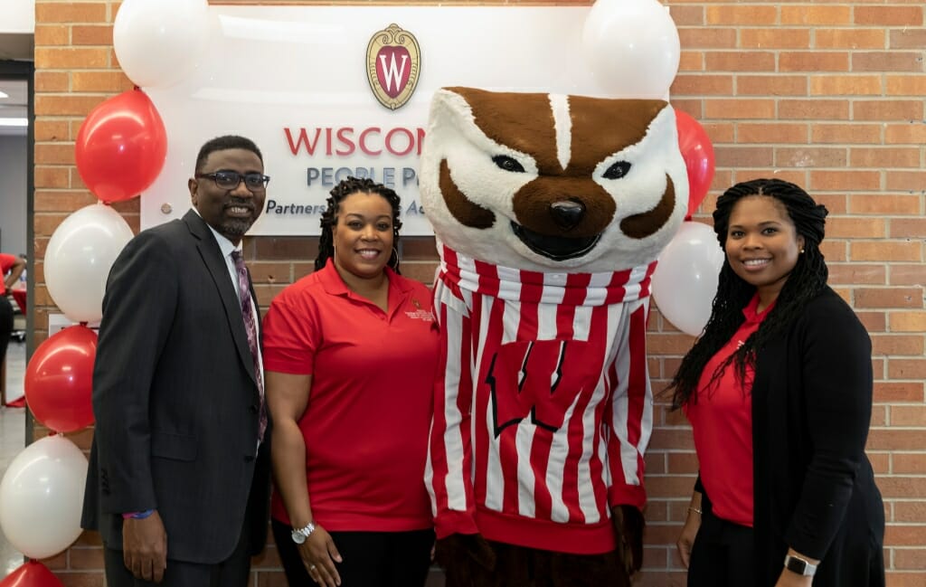 Photo: Bucky poses with staff members.