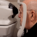Photo: Man looking into eye screening camera
