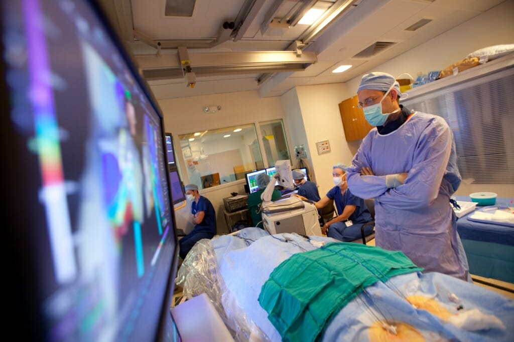Photo: A man looks at a screen connected to medical equipment.