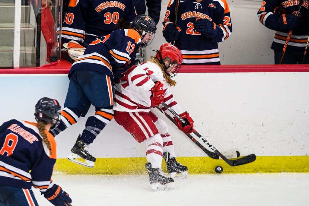 Wisconsin player Alexis Mauermann (14) battles for control of the puck.