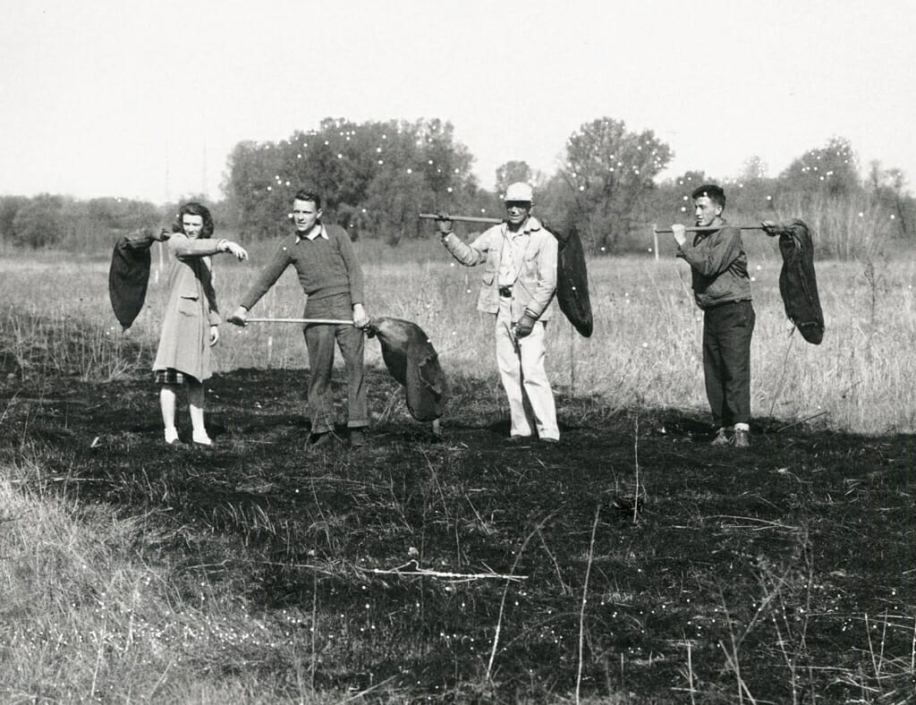 Photo: Leopold and others standing on burned ground