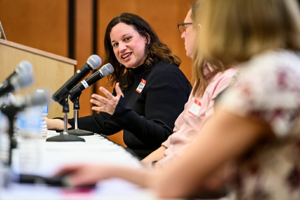 Photo: Veronica Rueckert speaking into a microphone