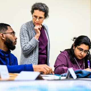 <strong>Chancellor’s Award for Excellence in Leadership at the Individual Unit Level: Susan M. Nossal</strong>
<br>Senior Scientist, Faculty Associate, Director, Physics Learning Center
<br><br><i>Susan Nossal works on optical calculations with undergraduate students Matthew McAllister and Hanna Khan in a classroom at Chamberlin Hall.</i><br><br>The university’s large introductory physics classes can be daunting to students, especially those who had limited exposure to the discipline in high school. In collaboration with others, Susan Nossal founded the Physics Learning Center 14 years ago to create a welcoming space for these students. The concept began as the Physics Peer Mentor Tutor Program, now the center’s core. Each semester, carefully trained undergraduates and staff members assist more than 150 students, many experiencing challenging circumstances inside and outside the classroom. The students develop confidence not only in physics, but in university life in general. Some go on to become tutors in the program themselves. Nossal sets a warm tone. Her caring demeanor and devotion to social justice foster powerful connections with students who may feel isolated or frustrated. Tenacious and resourceful, she’s grown the center into a forceful vehicle for student success.