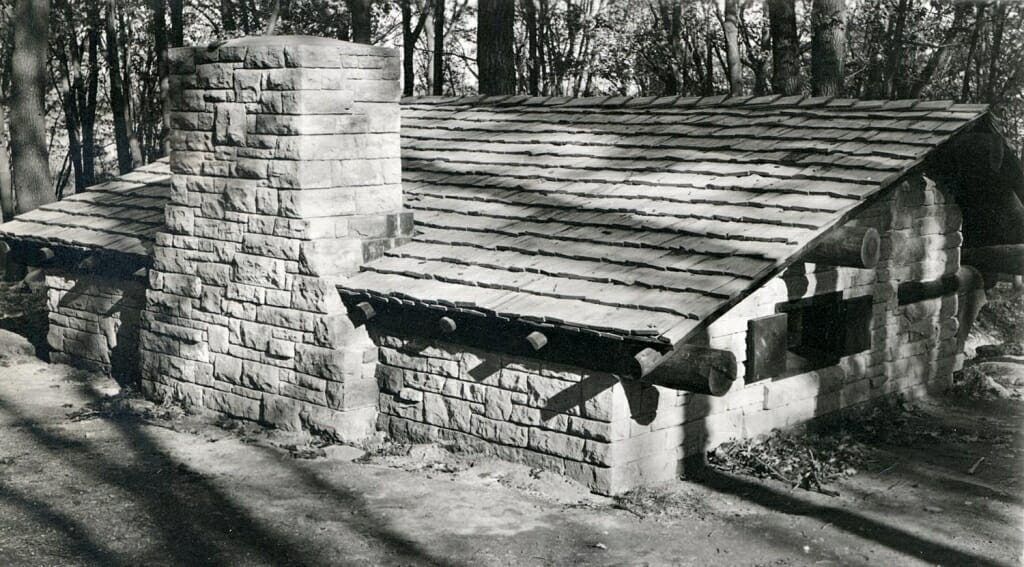 Photo: Exterior of stone building with large chimney