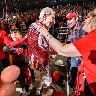 Photo: People shake Leckrone's hand and pat him on the back.