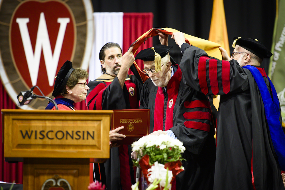 Photo of Thomas Brock being hooded for his honorary degree.