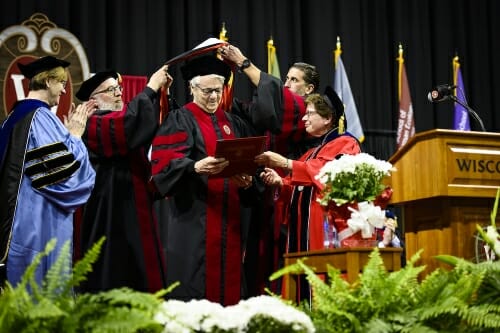 Photo of Steve Miller receiving his degree and academic regalia.