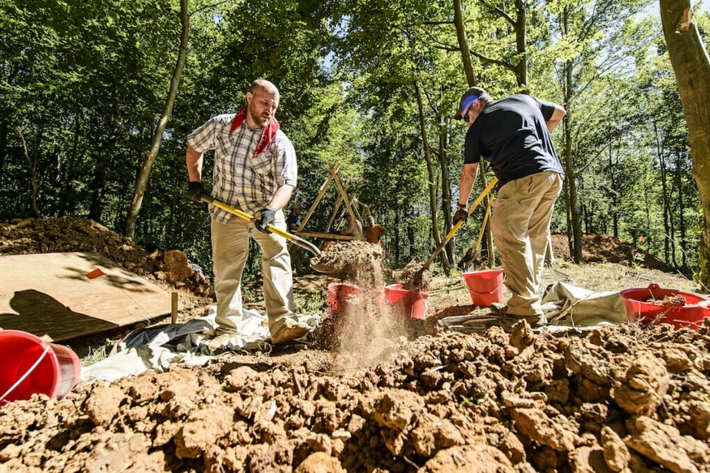 Photo: 2 men digging with shovels