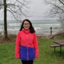 Photo of Yuli Liu standing on the Lake Michigan waterfront