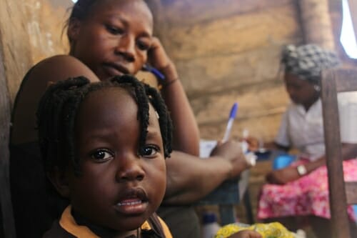 Photo: A woman and her daughter at a health clinic.