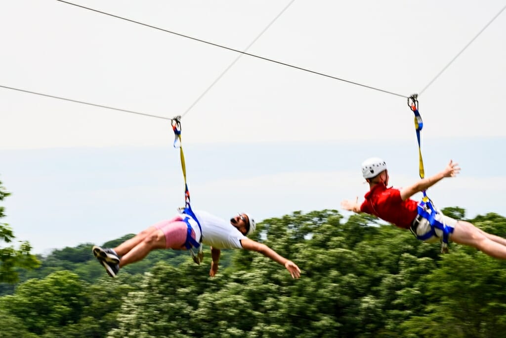 Photo: Two people zip along the zip lines.