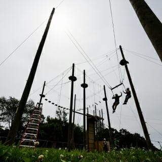 Photo: The ropes and pillars of the giant swing are silhouetted against the sun.