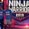 Photo: Green twins standing in front of Ninja show logo