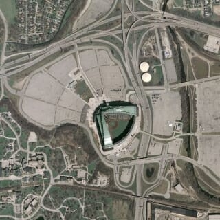 Photo: An aerial that shows a baseball park and its parking lots, as well as surrounding buildings.