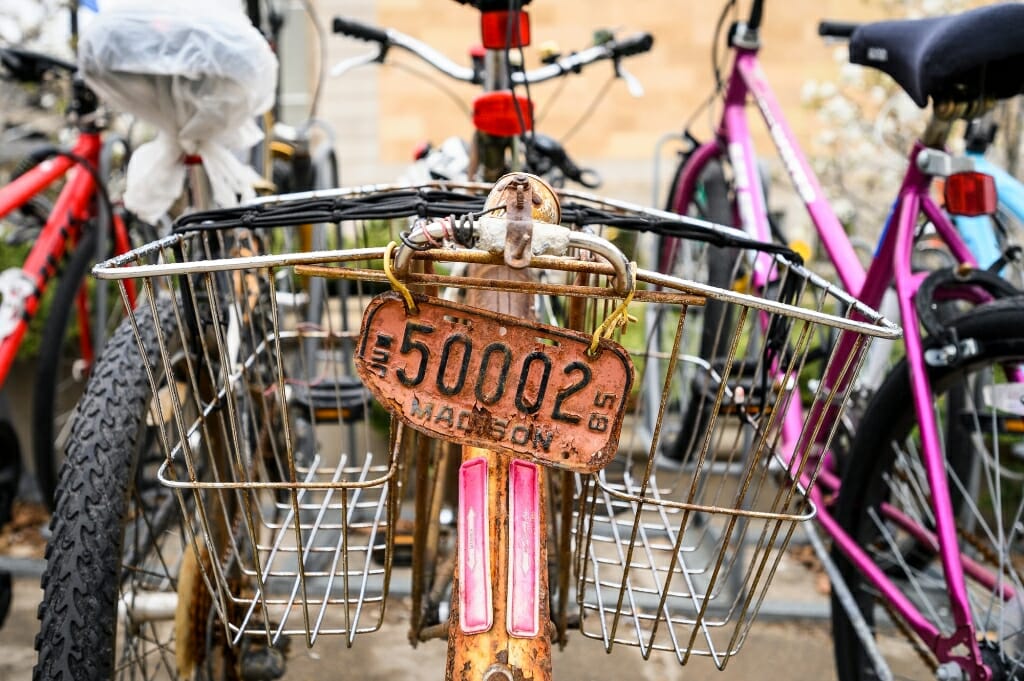 Photo: An old bike with a metal license plate and baskets.