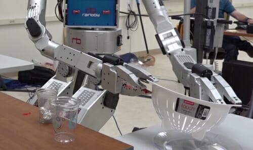 Photo: Closeup of robot's hands holding colander