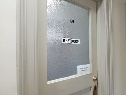 Photo of the door to a gender-inclusive restroom