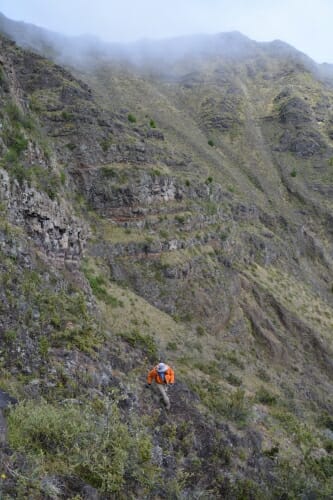 Photo: Man walking up side of volcano