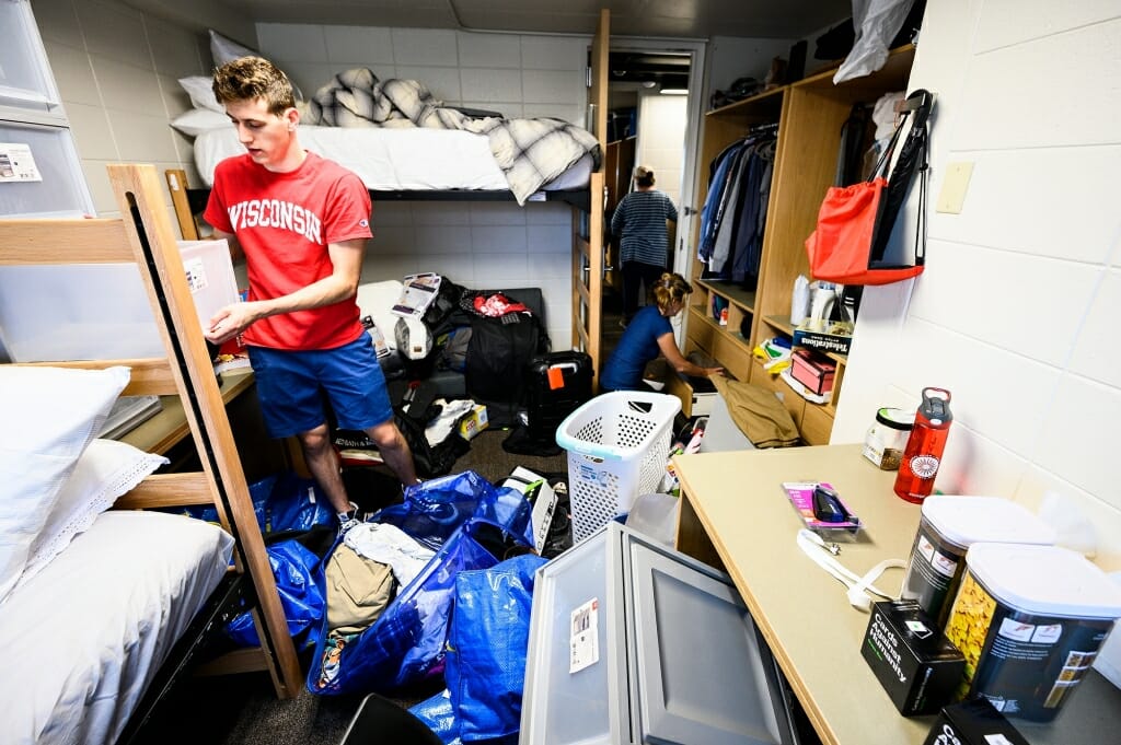 Photo of Jonah Katz surrounded by piles of belongings.