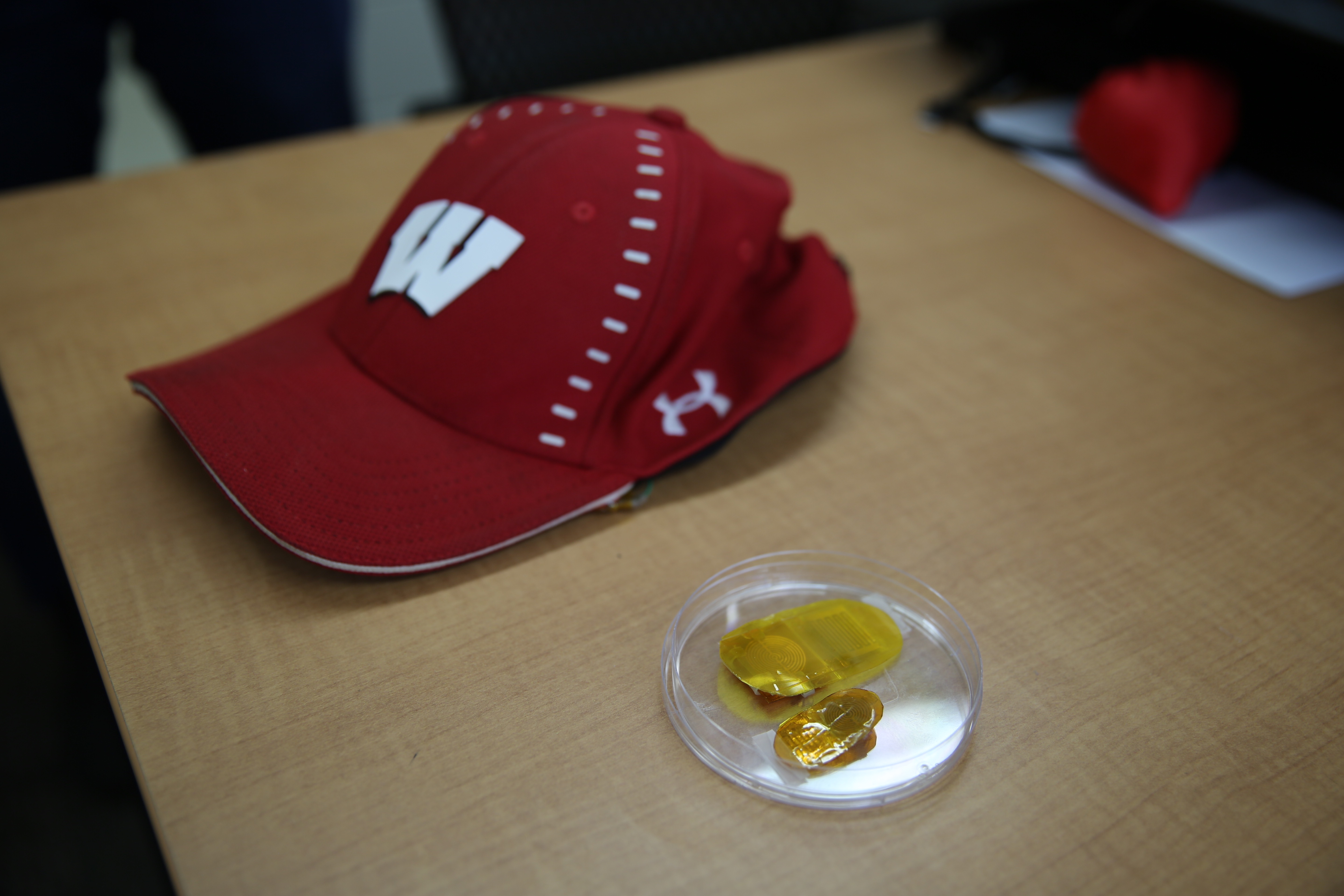 Photo: A baseball cap and a small yellow device.