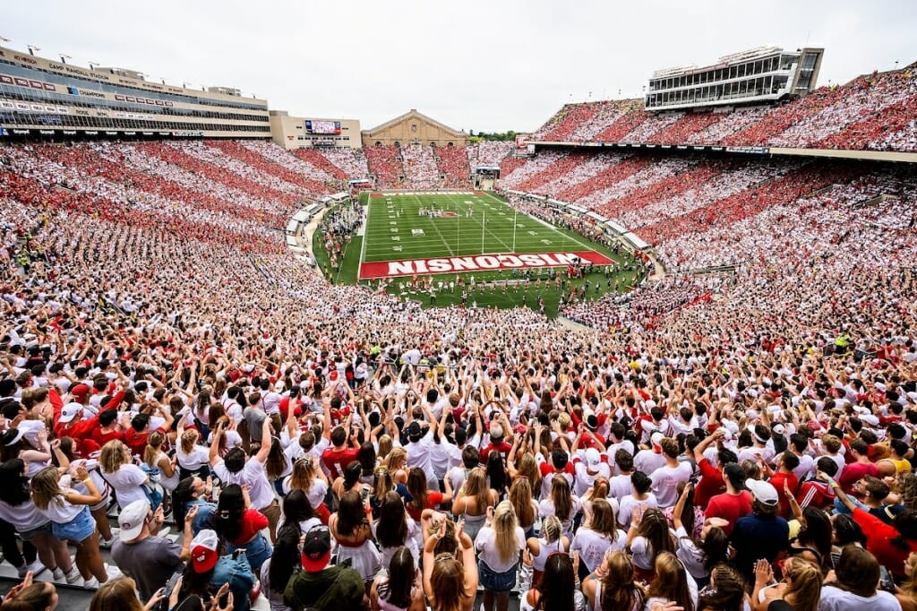 Photo: A look at Camp Randall stadium where it appears striped, as fans in alternating sections wear red and then white.