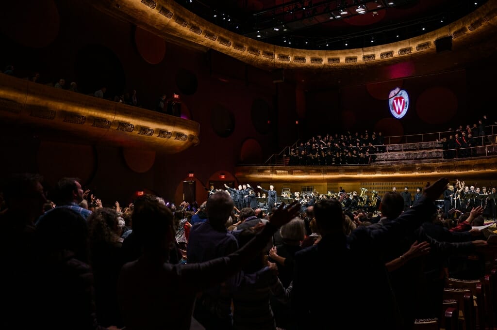 Photo: Crowd seen from behind waving arms