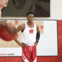 A basketball player stands on the court.