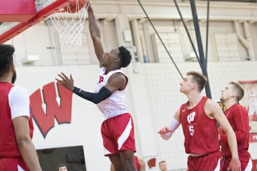 Photo: A basketball player dunks the ball.